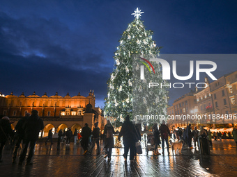 KRAKOW, POLAND - DECEMBER 20:   
An illuminated Christmas tree stands near St. Mary's Basilica in Krakow's UNESCO-listed Main Square, on Dec...