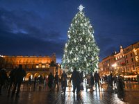 KRAKOW, POLAND - DECEMBER 20:   
An illuminated Christmas tree stands near St. Mary's Basilica in Krakow's UNESCO-listed Main Square, on Dec...