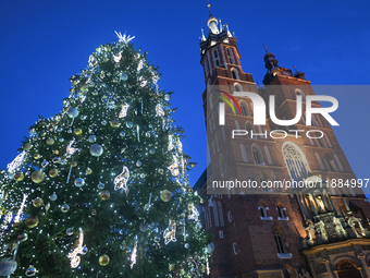 KRAKOW, POLAND - DECEMBER 20:   
An illuminated Christmas tree stands near St. Mary's Basilica in Krakow's UNESCO-listed Main Square, on Dec...