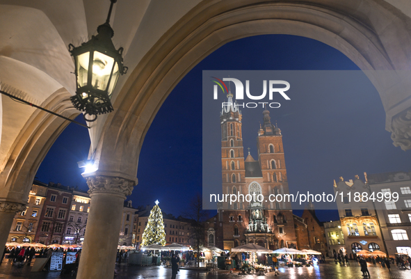 KRAKOW, POLAND - DECEMBER 20:   
An illuminated Christmas tree stands near St. Mary's Basilica in Krakow's UNESCO-listed Main Square, on Dec...