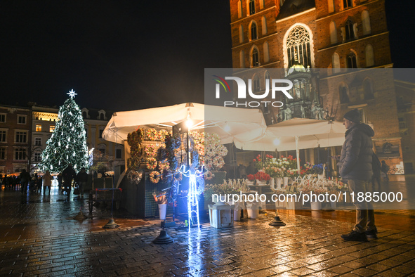 KRAKOW, POLAND - DECEMBER 20:   
An illuminated Christmas tree stands near St. Mary's Basilica in Krakow's UNESCO-listed Main Square, on Dec...