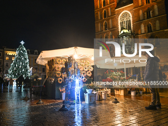 KRAKOW, POLAND - DECEMBER 20:   
An illuminated Christmas tree stands near St. Mary's Basilica in Krakow's UNESCO-listed Main Square, on Dec...