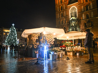 KRAKOW, POLAND - DECEMBER 20:   
An illuminated Christmas tree stands near St. Mary's Basilica in Krakow's UNESCO-listed Main Square, on Dec...