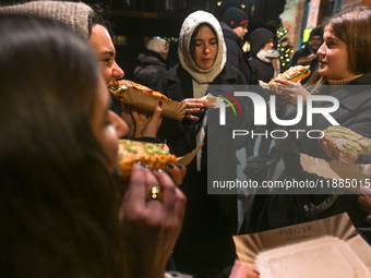 KRAKOW, POLAND - DECEMBER 20:   
People enjoy a traditional 'zapiekanka' - a toasted open-face sandwich with sliced baguette, sauteed white...