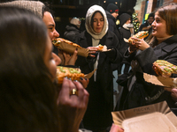 KRAKOW, POLAND - DECEMBER 20:   
People enjoy a traditional 'zapiekanka' - a toasted open-face sandwich with sliced baguette, sauteed white...