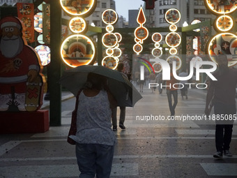 Pedestrians face strong storms in the center of Sao Paulo, Brazil, on December 20, 2024, this Friday afternoon. (