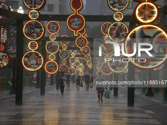 Pedestrians face strong storms in the center of Sao Paulo, Brazil, on December 20, 2024, this Friday afternoon. (