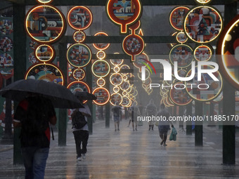 Pedestrians face strong storms in the center of Sao Paulo, Brazil, on December 20, 2024, this Friday afternoon. (