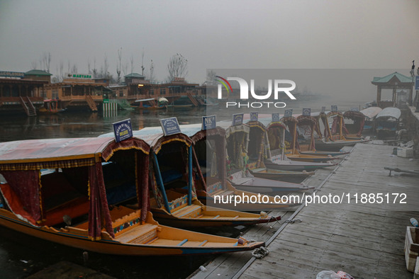 Shikara boats are moored to the bank of Dal Lake in Srinagar, Jammu and Kashmir, on December 21, 2024. The 40-day harsh winter period, local...