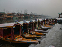 Shikara boats are moored to the bank of Dal Lake in Srinagar, Jammu and Kashmir, on December 21, 2024. The 40-day harsh winter period, local...