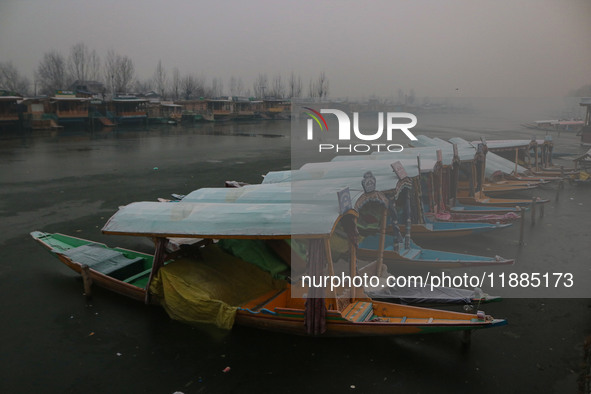 Shikara boats are moored to the bank of Dal Lake in Srinagar, Jammu and Kashmir, on December 21, 2024. The 40-day harsh winter period, local...