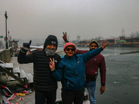 Indian tourists are seen on the banks of Dal Lake in Srinagar, Jammu and Kashmir, on December 21, 2024. The 40-day harsh winter period, loca...