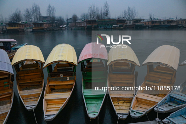 Shikara boats are moored to the bank of Dal Lake in Srinagar, Jammu and Kashmir, on December 21, 2024. The 40-day harsh winter period, local...