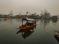 A boatman rows his boat on partially frozen waters at Dal Lake in Srinagar, Jammu and Kashmir, on December 21, 2024. The 40-day harsh winter...