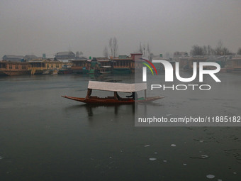 A boatman rows his boat on partially frozen waters at Dal Lake in Srinagar, Jammu and Kashmir, on December 21, 2024. The 40-day harsh winter...