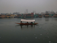 A boatman rows his boat on partially frozen waters at Dal Lake in Srinagar, Jammu and Kashmir, on December 21, 2024. The 40-day harsh winter...