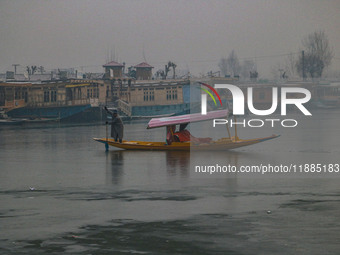 A boatman rows his boat on partially frozen waters at Dal Lake in Srinagar, Jammu and Kashmir, on December 21, 2024. The 40-day harsh winter...