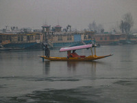 A boatman rows his boat on partially frozen waters at Dal Lake in Srinagar, Jammu and Kashmir, on December 21, 2024. The 40-day harsh winter...