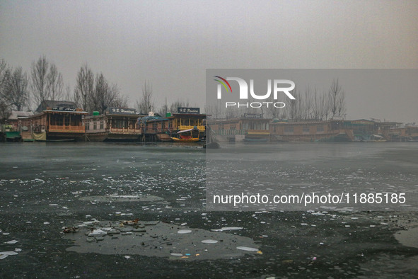 A boatman rows his boat on partially frozen waters at Dal Lake in Srinagar, Jammu and Kashmir, on December 21, 2024. The 40-day harsh winter...