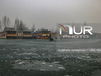 A boatman rows his boat on partially frozen waters at Dal Lake in Srinagar, Jammu and Kashmir, on December 21, 2024. The 40-day harsh winter...