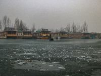 A boatman rows his boat on partially frozen waters at Dal Lake in Srinagar, Jammu and Kashmir, on December 21, 2024. The 40-day harsh winter...