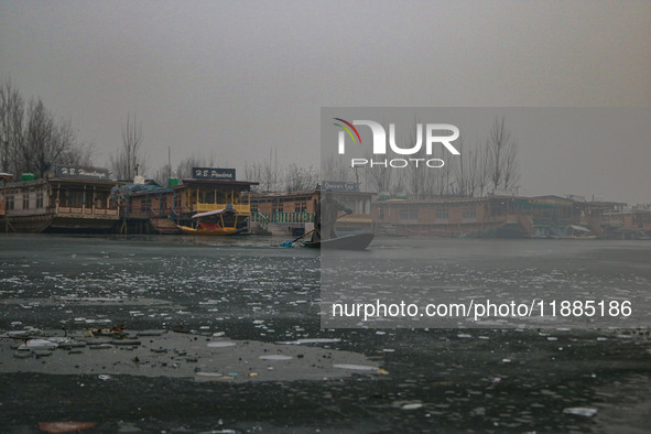 A boatman rows his boat on partially frozen waters at Dal Lake in Srinagar, Jammu and Kashmir, on December 21, 2024. The 40-day harsh winter...