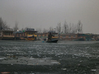 A boatman rows his boat on partially frozen waters at Dal Lake in Srinagar, Jammu and Kashmir, on December 21, 2024. The 40-day harsh winter...