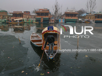 A boatman rows his boat on partially frozen waters at Dal Lake in Srinagar, Jammu and Kashmir, on December 21, 2024. The 40-day harsh winter...