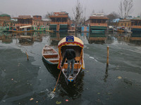 A boatman rows his boat on partially frozen waters at Dal Lake in Srinagar, Jammu and Kashmir, on December 21, 2024. The 40-day harsh winter...