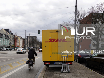 A DHL delivery vehicle parks in a residential area in Munich, Bavaria, Germany, on December 20, 2024 (