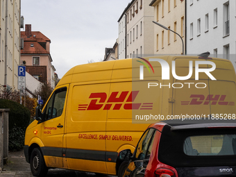 A DHL delivery vehicle parks in a residential area in Munich, Bavaria, Germany, on December 20, 2024 (