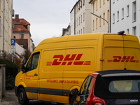 A DHL delivery vehicle parks in a residential area in Munich, Bavaria, Germany, on December 20, 2024 (