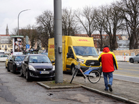 A DHL delivery vehicle parks in a residential area in Munich, Bavaria, Germany, on December 20, 2024 (