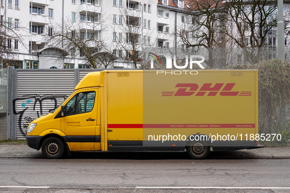 A DHL delivery vehicle parks in a residential area in Munich, Bavaria, Germany, on December 20, 2024 