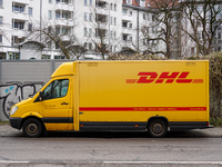 A DHL delivery vehicle parks in a residential area in Munich, Bavaria, Germany, on December 20, 2024 (