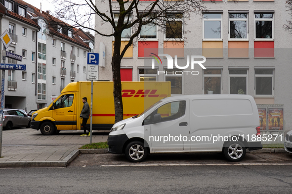 A DHL delivery vehicle parks in a residential area in Munich, Bavaria, Germany, on December 20, 2024 