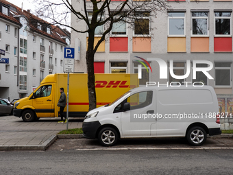 A DHL delivery vehicle parks in a residential area in Munich, Bavaria, Germany, on December 20, 2024 (