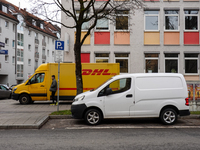 A DHL delivery vehicle parks in a residential area in Munich, Bavaria, Germany, on December 20, 2024 (