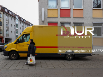 A DHL delivery vehicle parks in a residential area in Munich, Bavaria, Germany, on December 20, 2024 (