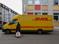 A DHL delivery vehicle parks in a residential area in Munich, Bavaria, Germany, on December 20, 2024 (