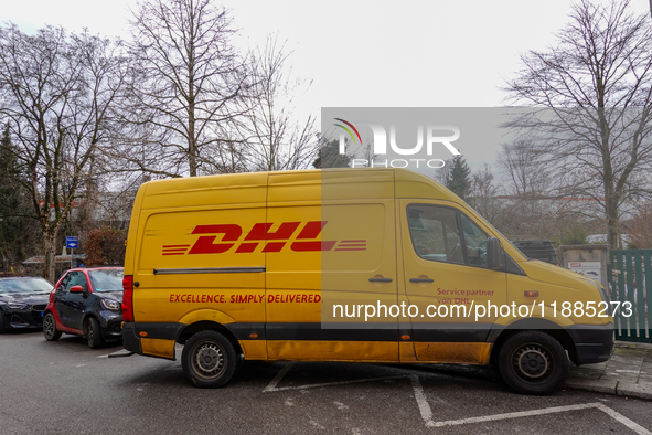 A DHL delivery vehicle parks in a residential area in Munich, Bavaria, Germany, on December 20, 2024 