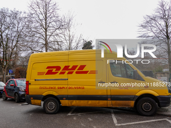 A DHL delivery vehicle parks in a residential area in Munich, Bavaria, Germany, on December 20, 2024 (