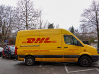 A DHL delivery vehicle parks in a residential area in Munich, Bavaria, Germany, on December 20, 2024 (