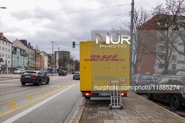 A DHL delivery vehicle parks in a residential area in Munich, Bavaria, Germany, on December 20, 2024 