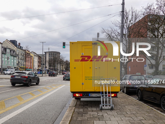 A DHL delivery vehicle parks in a residential area in Munich, Bavaria, Germany, on December 20, 2024 (