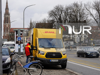 A DHL delivery vehicle parks in a residential area in Munich, Bavaria, Germany, on December 20, 2024 (