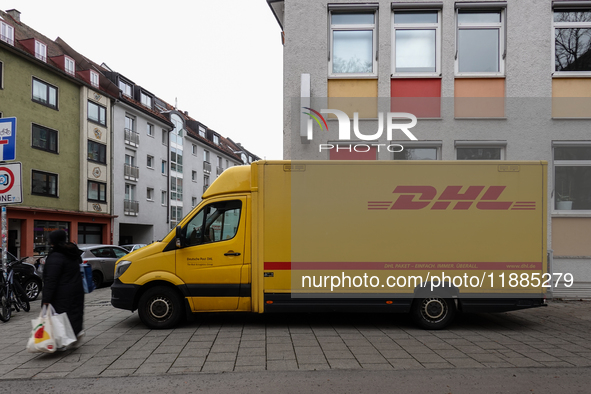 A DHL delivery vehicle parks in a residential area in Munich, Bavaria, Germany, on December 20, 2024 