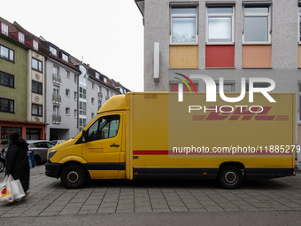 A DHL delivery vehicle parks in a residential area in Munich, Bavaria, Germany, on December 20, 2024 (