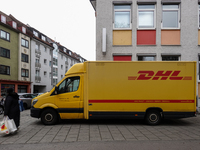 A DHL delivery vehicle parks in a residential area in Munich, Bavaria, Germany, on December 20, 2024 (