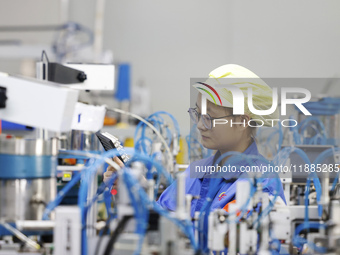 A worker produces photoelectric cables for export at a workshop of a communication equipment company in the Sihong Economic Development Zone...